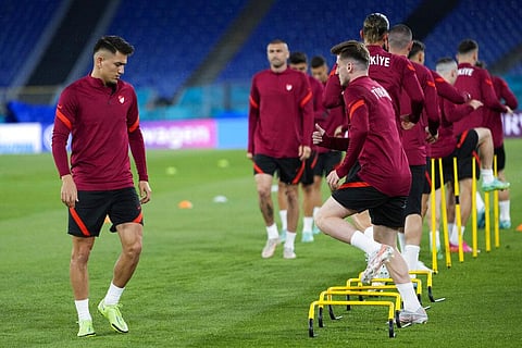 Turkey's Cengiz Under, left, works out with teammates during a training session of the national soccer team at the Olympic stadium in Rome. (Photo | AP)