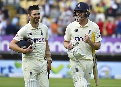 England's Dan Lawrence, right, and batting partner Mark Wood walk off the field at the end of play on the first day of the second cricket Test. (Photo | AP)
