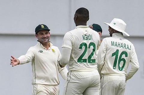 Dean Elgar (L) and Lungi Ngidi (C) of South Africa celebrate the dismissal of Rahkeem Cornwall of West Indies during day one of the first Test between South Africa and West Indies. (Photo | AFP)