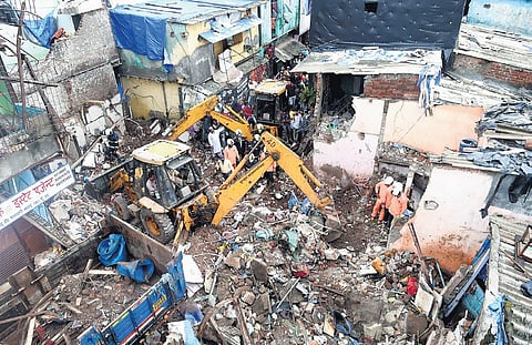A rescue operation underway on Thursday after a single-storey house collapsed onto another structure in Mumbai’s Malwani area on Wednesday night. (Photo | PTI)
