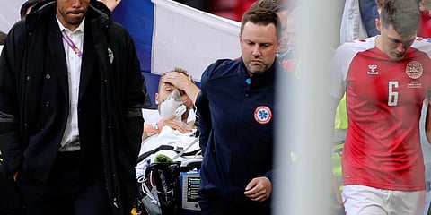 Paramedics using a stretcher to take out of the pitch Denmark's Christian Eriksen after he collapsed during an Euro 2020 match against Finland. (Photo| AP)