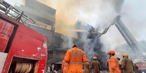 Fire officials trying to control fire at Central Market in Lajpat Nagar in Delhi. (Photo | Shekhar Yadav, EPS)