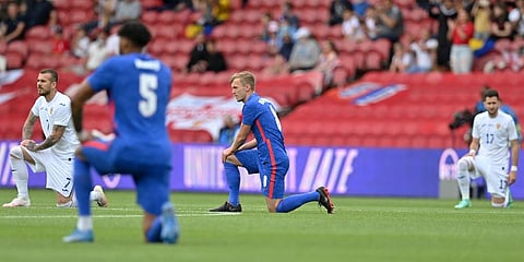 England's and Romania's players take a knee before the international friendly soccer match between England and Romania in Middlesbrough. (Photo | AP)