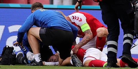 Christian Eriksen lays on the ground after collapsing during the Euro 2020 soccer championship group B match between Denmark and Finland at Parken stadium in Copenhagen. (Photo | AP)
