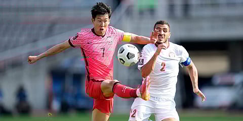 South Korea's Son Heung-min (L) fights for the ball against Lebanon's Kassem El Zein during their Asian zone Group H qualifying match for the FIFA World Cup Qatar 2022 at Goyang Stadium. (Photo | AP)