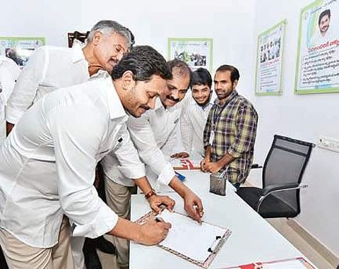 Jagan signs in the visitor’s book during inauguration of Village Secretariat system at Karapa in East Godavari district. (File Photo | EPS)