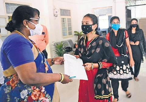 Students receive application forms at the Presidency Government Girls Higher Secondary School in Chennai on Monday | DEBADATTA MALLICK