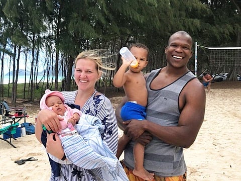 Lindani Myeni standing on a beach in Waimanalo, Hawaii with his wife and two children. (Photo | AP)
