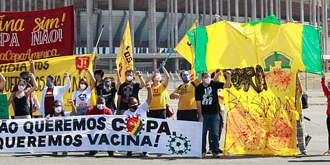 People protest Brazil's hosting the soccer Copa America tournament amidst the COVID-19 pandemic and against Brazil's President Jair Bolsonaro in Brasilia. (Photo | AP)
