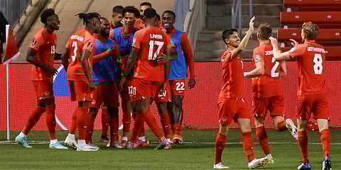 Canada's Cyle Larin (17) celebrates with teammates after scoring against Haiti during the second half of a World Cup qualifying soccer match in Bridgeview, Ill. (Photo | AP)