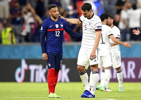 France's Corentin Tolisso, left, comforts Germany's Mats Hummels during the Euro 2020 soccer championship group F match between France and Germany. (Photo | AP)
