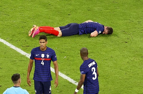 France's Benjamin Pavard lies on the pitch after Germany's Robin Gosens hit him with his knee during the Euro 2020 soccer championship group F match. (Photo | AP)