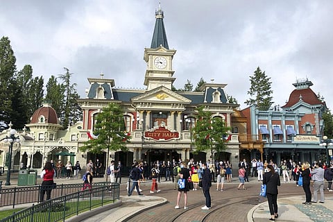 Visitors wait to enter Disneyland Paris in Marne-la-Vallée, east of Paris.