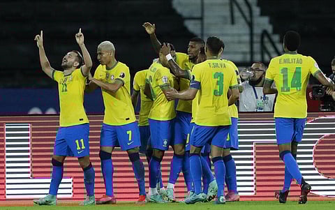 Brazil's Everton Ribeiro celebrates with teammates after scoring his side's third goal during a Copa America soccer match against Peru. (Photo | AP)