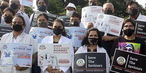 IMA doctors hold placards during a nationwide protest, demanding a central law to protect doctors against violence. (Photo | PTI)