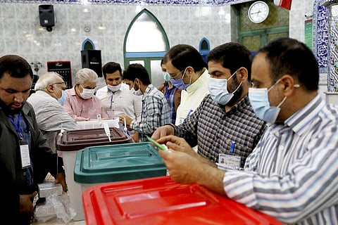 Iranian election officials prepare ballot boxes at a polling station in Tehran, Iran, Friday, June 18, 2021. Iran began voting Friday in a presidential election. (Photo | AP)
