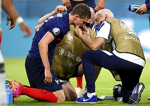 France's Benjamin Pavard gets medical assistance during the Euro 2020 soccer championship group F match between France and Germany. (Photo | AP)