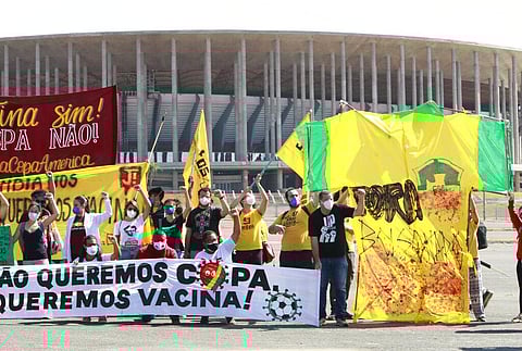 People protest Brazil's hosting the soccer Copa America tournament amidst the COVID-19 pandemic and against Brazil's President Jair Bolsonaro in Brasilia. (Photo | AP)