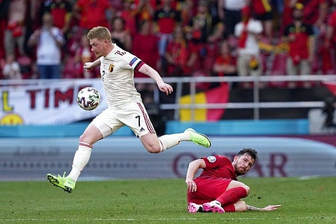 Belgium's Kevin De Bruyne jumps over Denmark's Pierre-Emile Hojbjerg during the Euro 2020 soccer championship group B match between Denmark and Belgium. (Photo | AP)