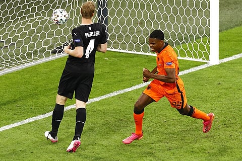Netherlands' Denzel Dumfries, center, celebrates after scoring against Austria during the Euro 2020 soccer championship group C match between Netherland and Austria. (Photo | AP)