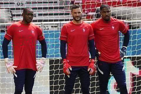 France's goalkeeper Hugo Lloris, center, France's goalkeeper Mike Maignan, right, and France's goalkeeper Steve Mandanda attend a training session. (Photo | AP)