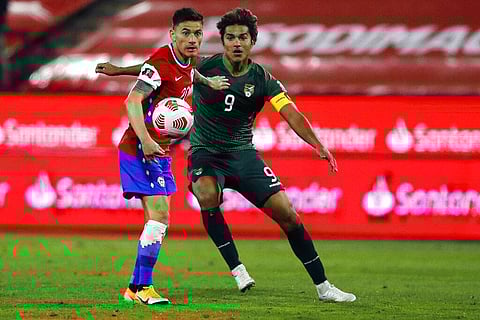 Chile's Charles Aranguiz, left, and Bolivia's Marcelo Martins battle for the ball during a qualifying soccer match for the FIFA World Cup Qatar 2022. (Photo | AP)
