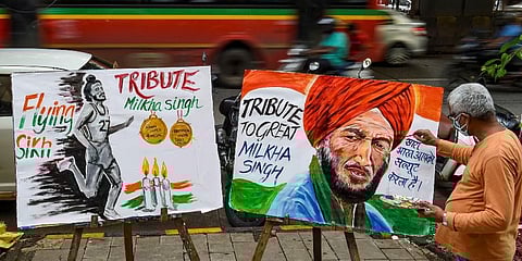 An art teacher draws a painting of Indian athelete Milkha Singh as a tribute after he died following post COVID complications, in Mumbai, Saturday, June 19, 2021. (Photo | PTI)