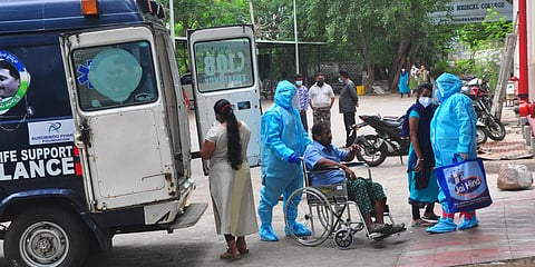 Health workers shifting a COVID patient from ambulance to COVID block at King George Hospital in Visakhapatnam. (Photo| G Satyanarayana, EPS)