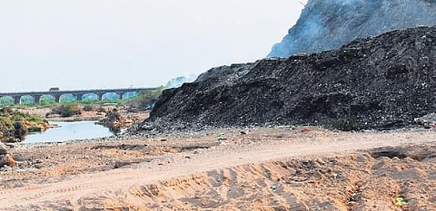 The mammoth heap of garbage collected on the outskirts of Karimnagar slips into the Manair river beside it during monsoons, causing pollution of the river.