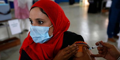 A teacher receives the first shot the Sinovac coronavirus vaccine in Lahore. (Photo | AP)