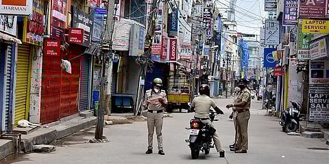 Police personnel keep vigil on SP Road in Bengaluru on Thursday | EXPRESS
