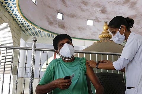 A man is administered the Covishield vaccine during a vaccination drive against COVID-19 at a mosque in Ahmedabad. (Photo | AP)