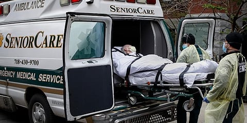 A patient is loaded into an ambulance by emergency medical workers outside Cobble Hill Health Center in the Brooklyn borough of New York. (Photo | AP)