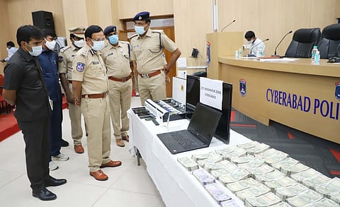 Cyberabad police commissioner VC Sajjanar and other senior cops with the seized cash and betting devices. (Photo | EPS)