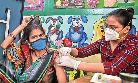 A woman receives a jab at a vaccination centre in New Delhi. (Photo| Shekhar Yadav, EPS)