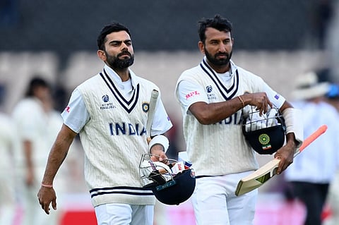 India's Virat Kohli (L) and Cheteshwar Pujara leave the pitch at end of play on fifth day of WTC Final between against New Zealand at Ageas Bowl, Southampton, England on June 22, 2021. (Photo | AFP)