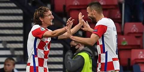 Croatia's midfielder Luka Modric (L) celebrates with midfielder Mateo Kovacic after scoring against Scotland. (Photo | AFP)