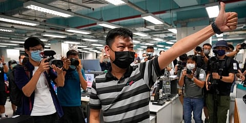 Lam Man-chung, Executive Editor-in-Chief of Apple Daily gesture at the headquarters in Hong Kong. newspaper will stop publishing Thursday, following last week's arrest of five editors and executives a