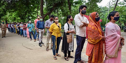 Beneficiaries wait to receive a dose of COVID-19 vaccine at Moti Lal Nehru Medical College vaccination center, in Prayagraj. (Photo | PTI)