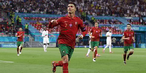 Portugal's Cristiano Ronaldo celebrates after scoring his second goal during an Euro 2020 group F match against France. (Photo| AP)