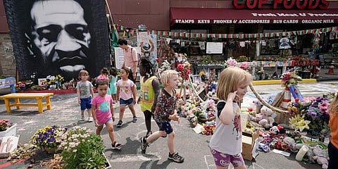 Preschool children visit the site where George Floyd was murdered by then Minneapolis Police officer Derek Chauvin, as the kids took a field trip to the memorial. (Photo | AP)