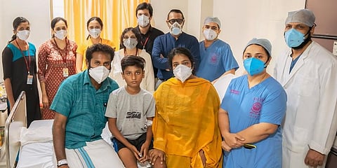 Adhik with parents and doctors.