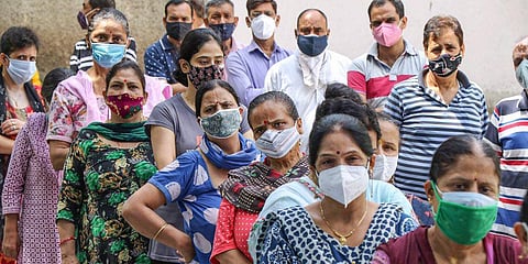 People wait for their second dose of COVID-19 vaccine, at a vaccination center, in Jammu. (Photo | PTI)