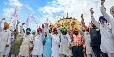 Farmer shout slogans during a protest against three farm reform laws, and over other issues at the Golden Gate in Amritsar. (Photo | PTI)