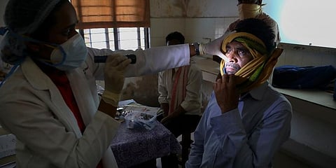 A doctor checks a man who recovered from COVID-19 and now infected with black fungus at the Mucormycosis ward of a government hospital in Hyderabad. (Photo | AP)