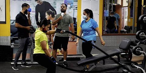 Fitness enthusiasts workout in a gym that reopened after authorities eased COVID-induced restrictions, in New Delhi, June 28, 2021. (Photo| PTI )