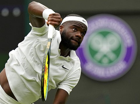 Frances Tiafoe of the US serves to Stefanos Tsitsipas of Greece during the men's singles match on day one of the Wimbledon Tennis Championships in London. (Photo | AP)