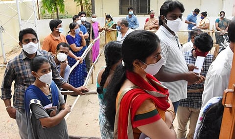 People stand in a queue at a PHC in Tirupati on Monday for vaccination (Photo I EPS)K