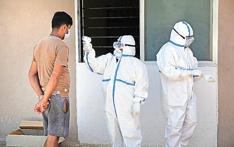 A health worker measures the body temperature of a patient at a Covid Care Centre in Bengaluru on Wednesday | Ashishkrishna HP