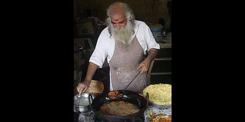 Raghunath preparing snacks at his stall at Chagampuzha Park, Edappally.